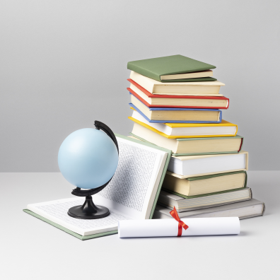 Front view of stacked books, a diploma and an earth globe with copy space for education day
