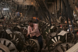 A man in the middle of a weaving mill
