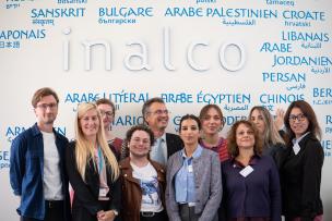 Photo de groupe des participants et participantes du premier workshop LANG-PACT, posant devant la fresque des langues de l'Inalco